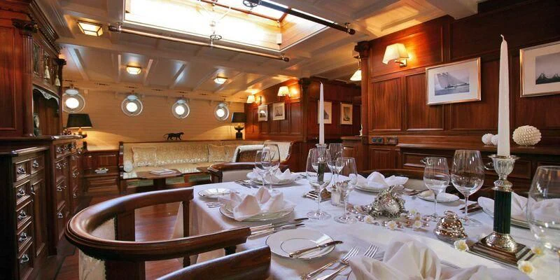 a large dining room table aboard ELEONORA E Yacht for Sale