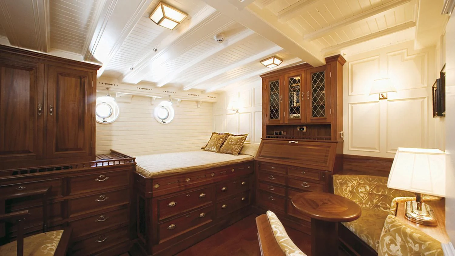 a bedroom with a bed and a desk aboard ELEONORA E Yacht for Sale