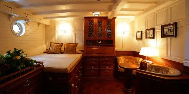 a room with a bed and a dresser aboard ELEONORA E Yacht for Sale