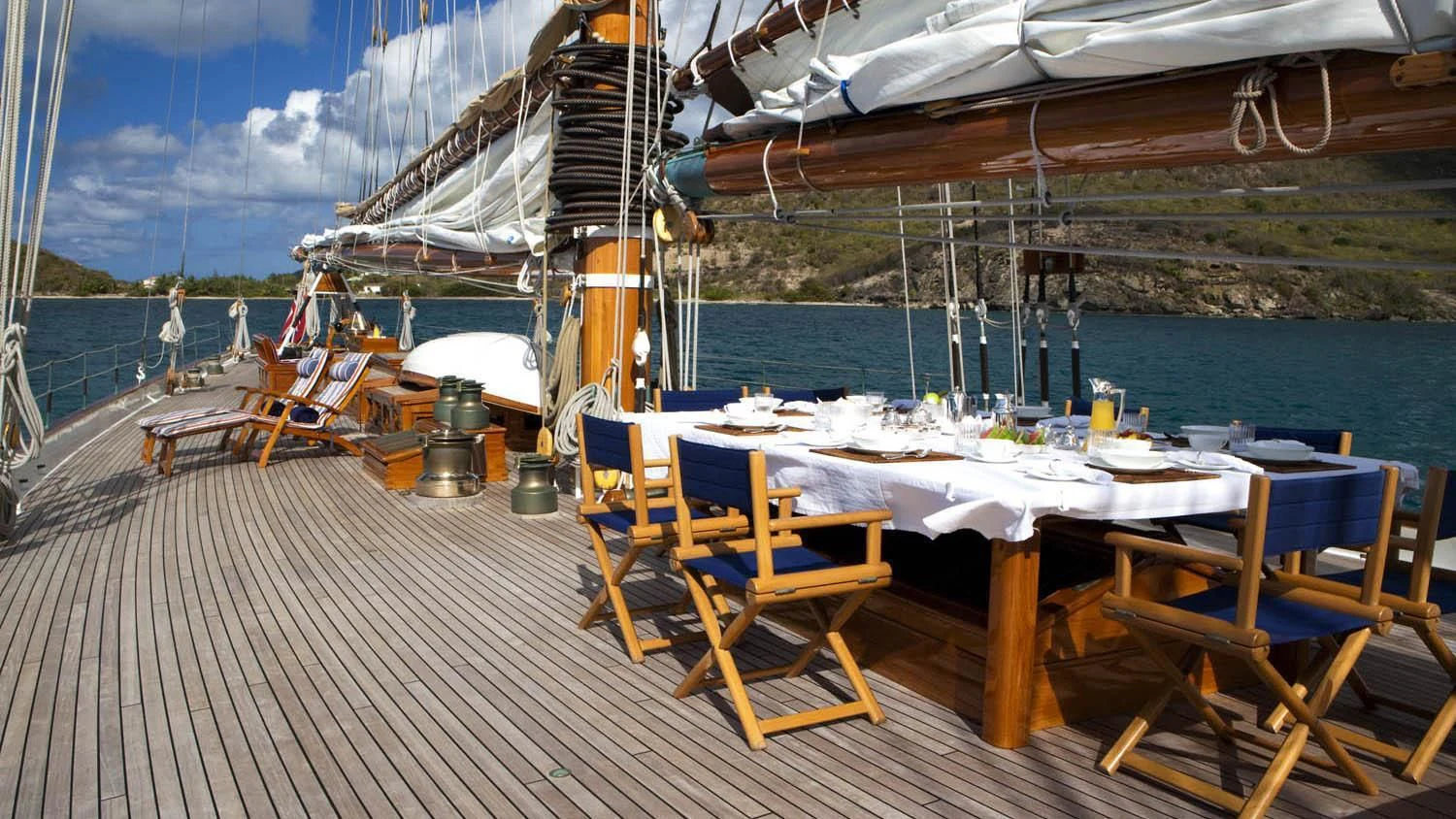 a deck with tables and chairs on it aboard ELEONORA E Yacht for Sale