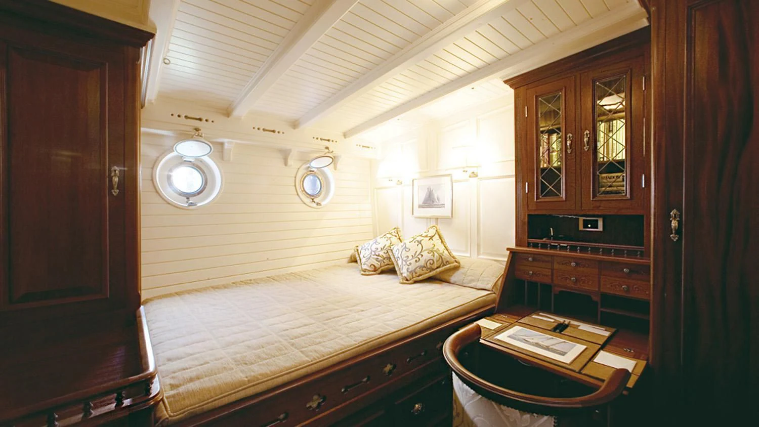 a bedroom with a bed and desk aboard ELEONORA E Yacht for Sale