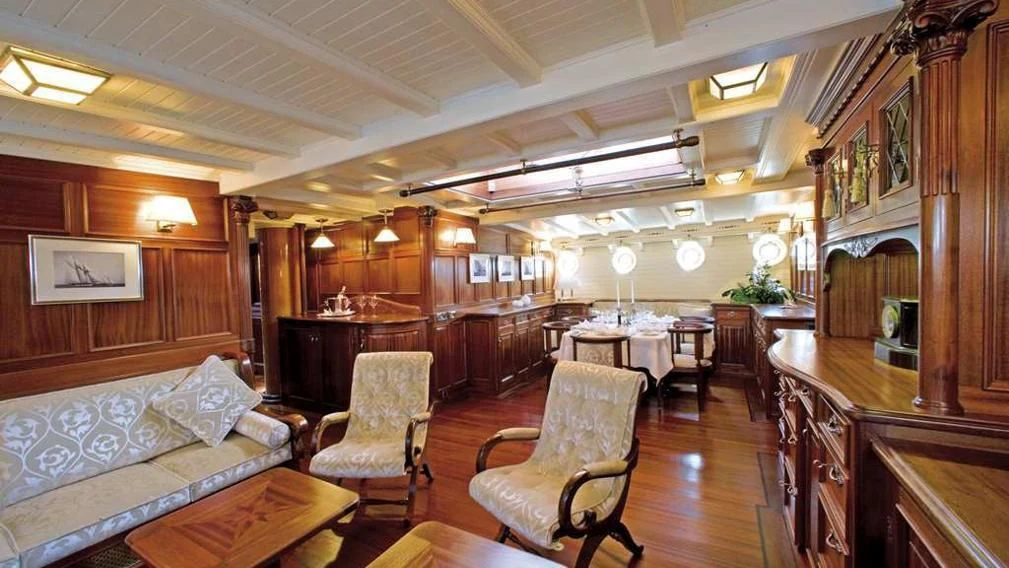 a large living room with wood walls aboard ELEONORA E Yacht for Sale