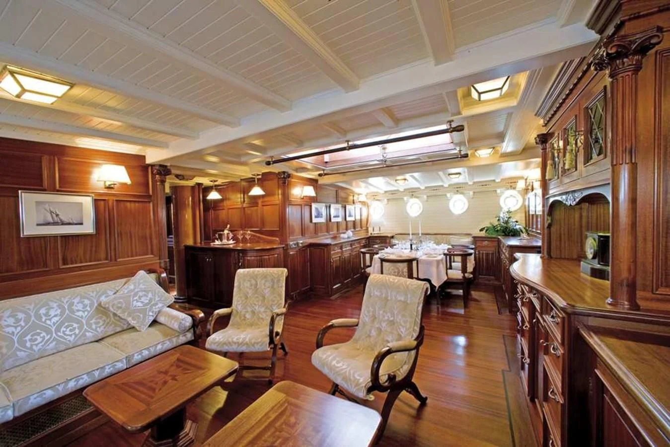 a large living room with wood floors aboard ELEONORA E Yacht for Sale