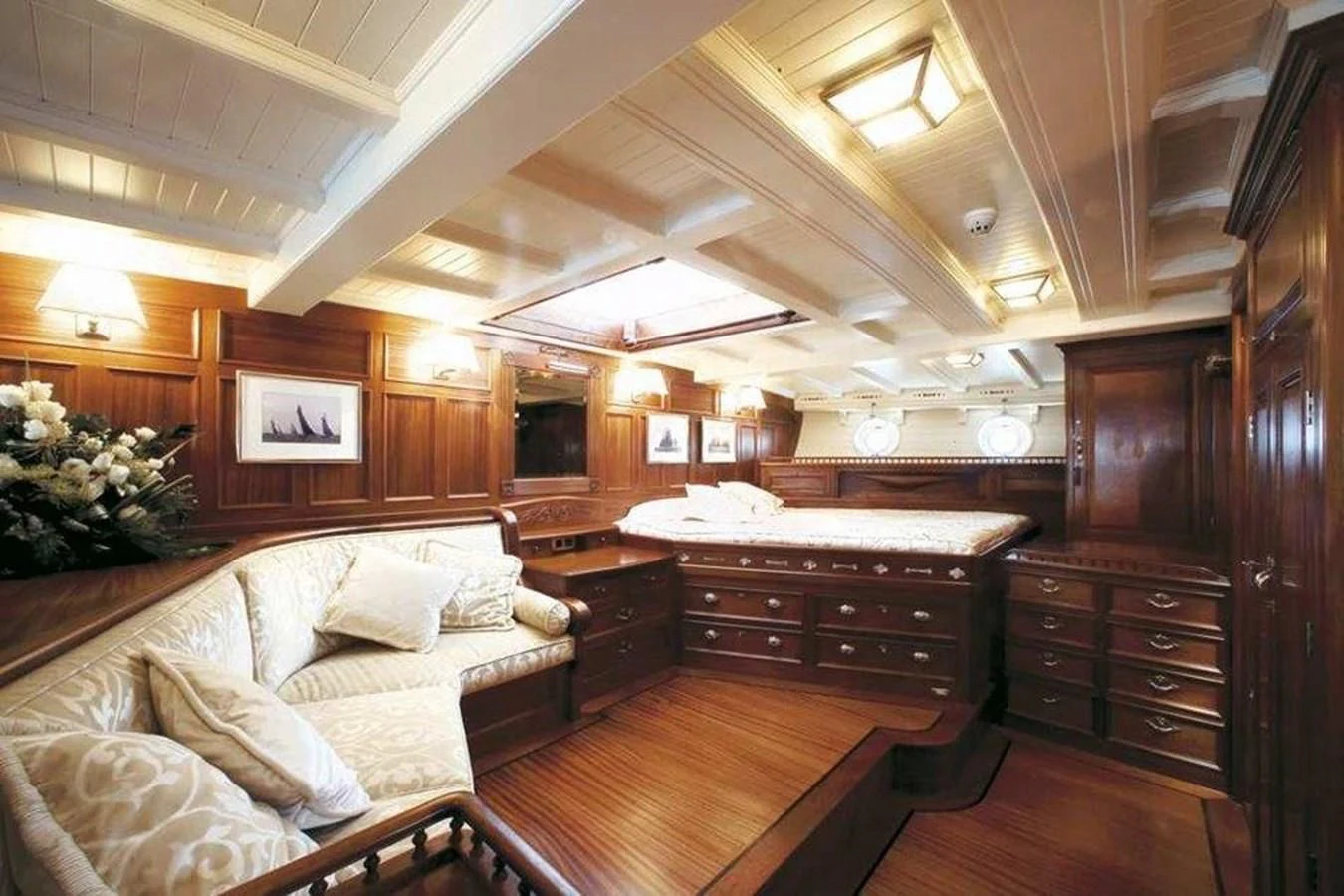 a bedroom with a bed and a dresser aboard ELEONORA E Yacht for Sale
