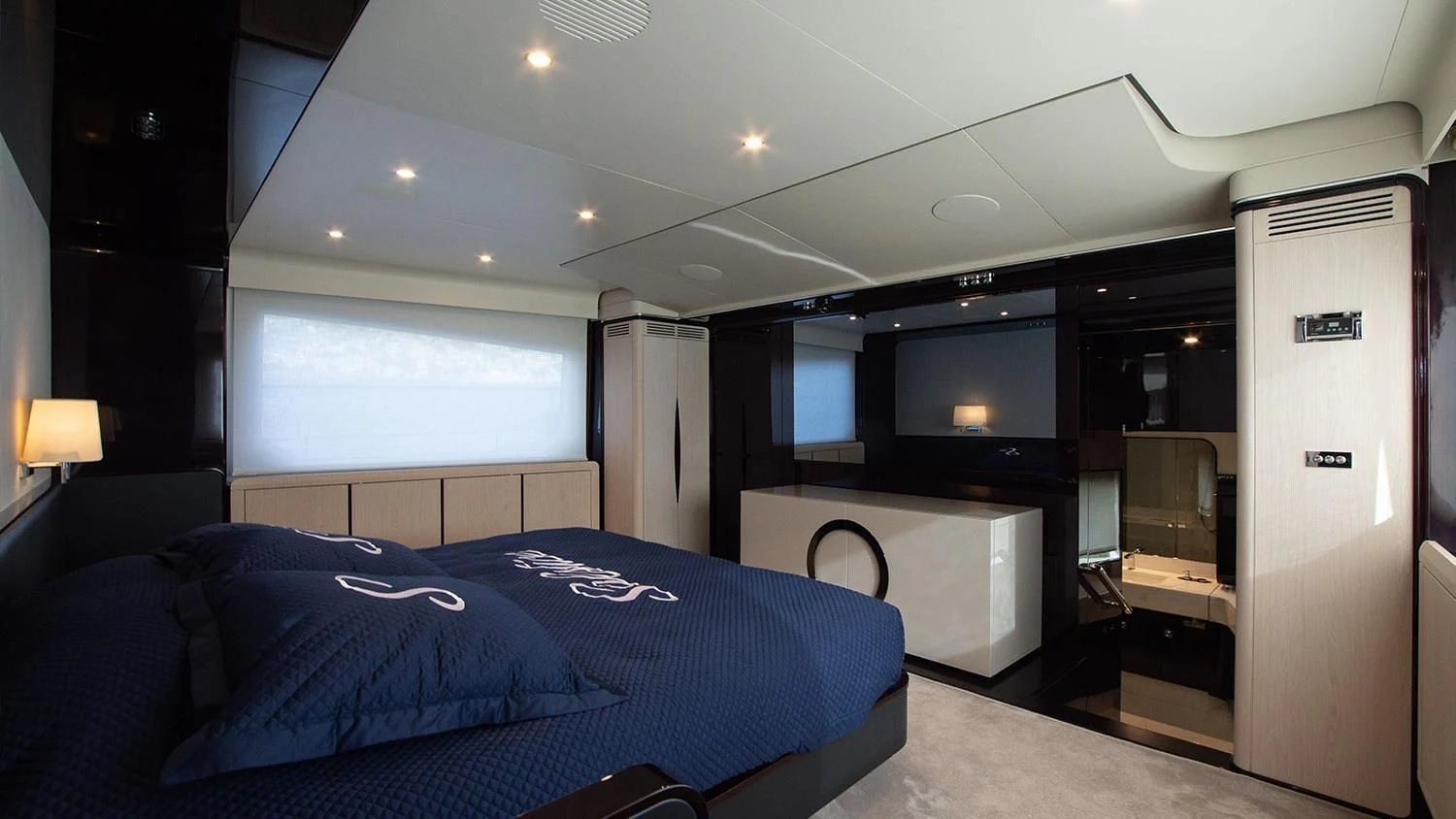 a bedroom with a bed and a desk aboard SOLSTICE Yacht for Sale