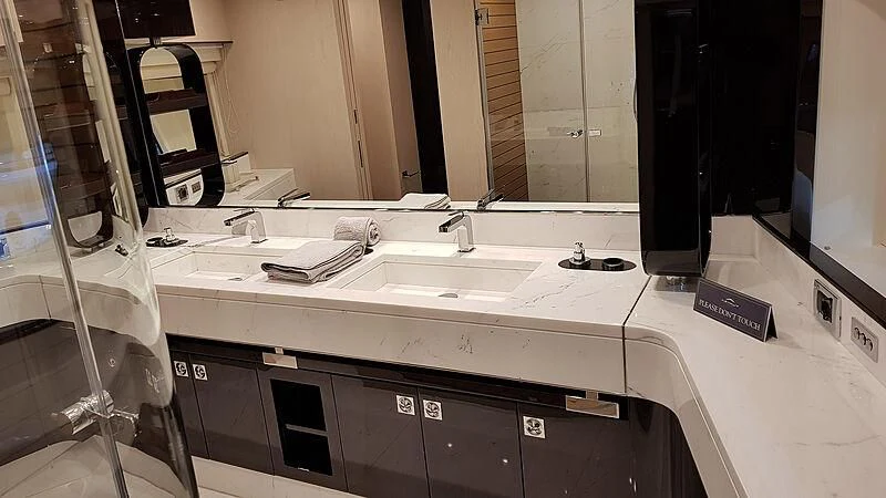 a bathroom with a large mirror aboard SOLSTICE Yacht for Sale
