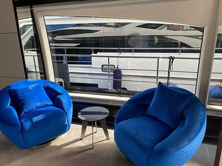 a couple of blue chairs in front of a window aboard SOLSTICE Yacht for Sale