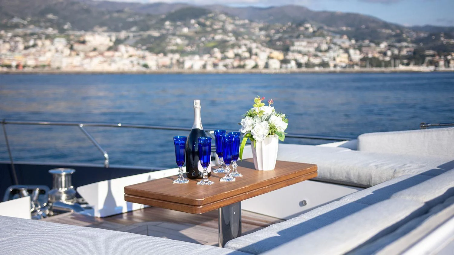 a table with flowers on it by a body of water aboard SOLSTICE Yacht for Sale