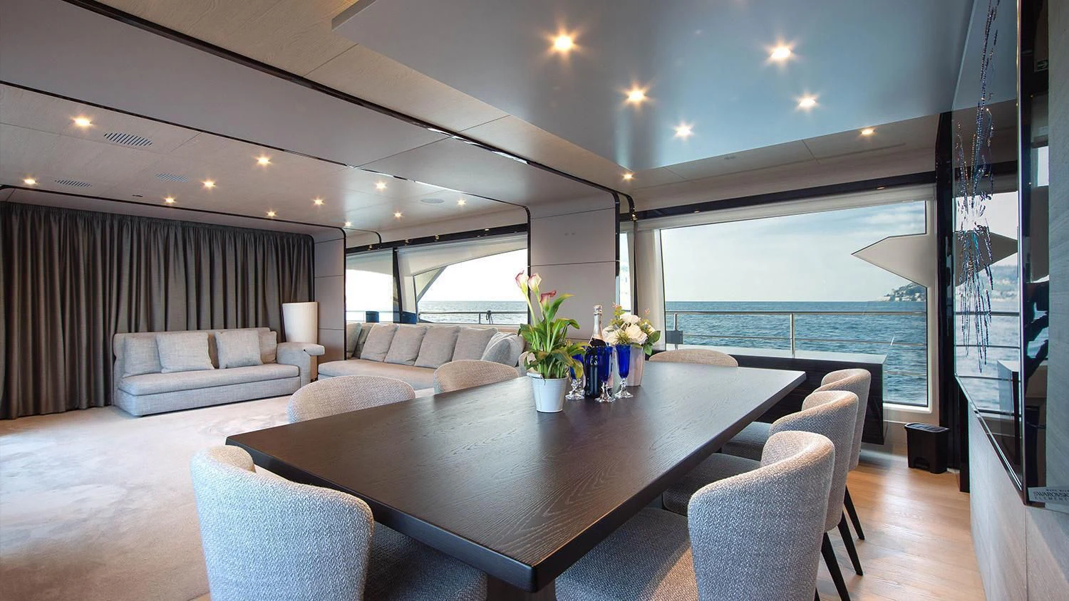a living room with a large window aboard SOLSTICE Yacht for Sale