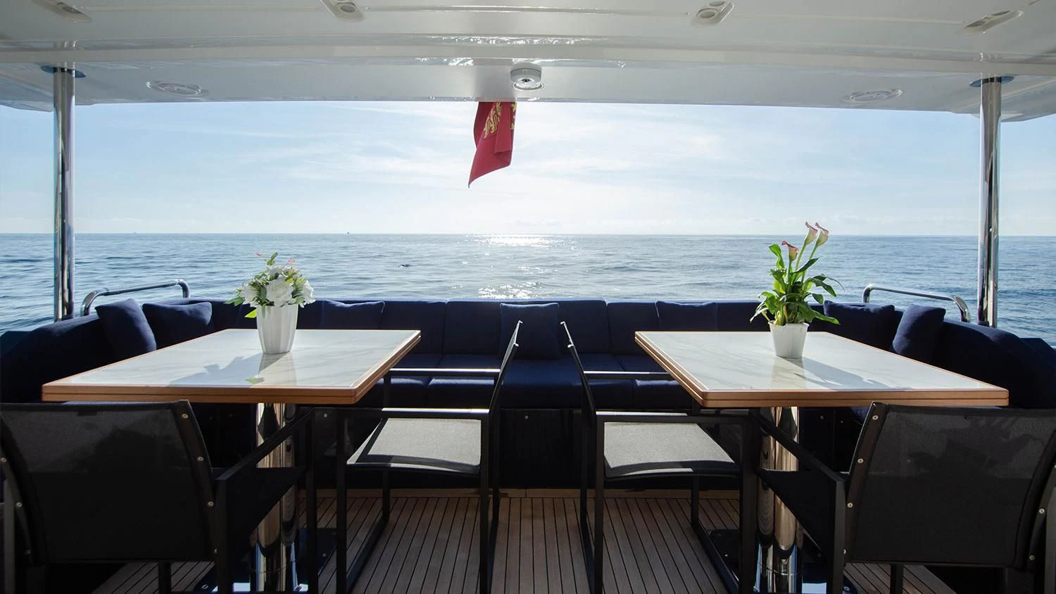 a room with tables and chairs aboard SOLSTICE Yacht for Sale