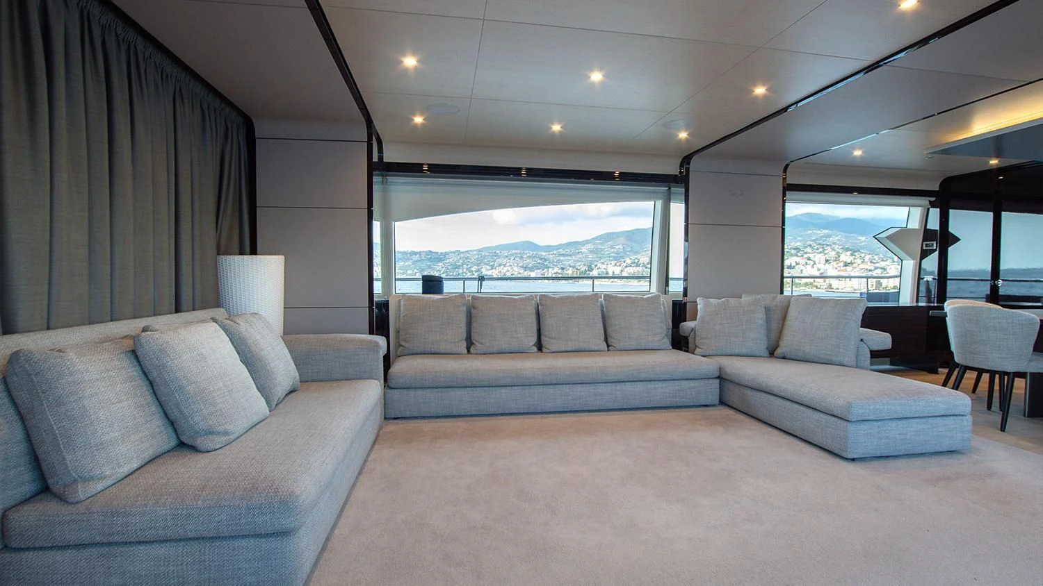 a living room with a couch and a large window aboard SOLSTICE Yacht for Sale