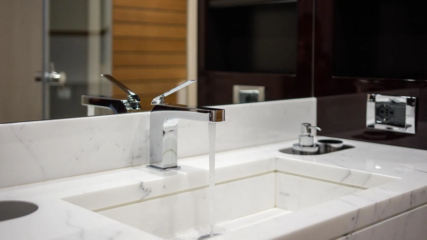 a bathroom with a sink and a mirror aboard SOLSTICE Yacht for Sale