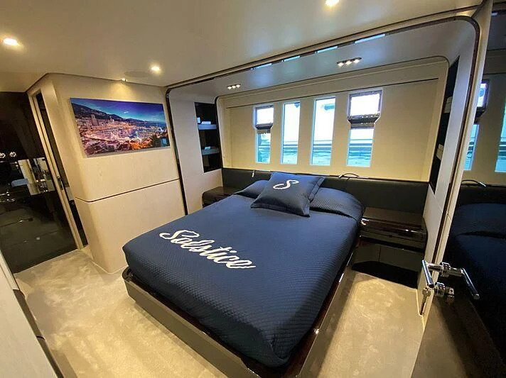 a room with a bed and a tv on the wall aboard SOLSTICE Yacht for Sale