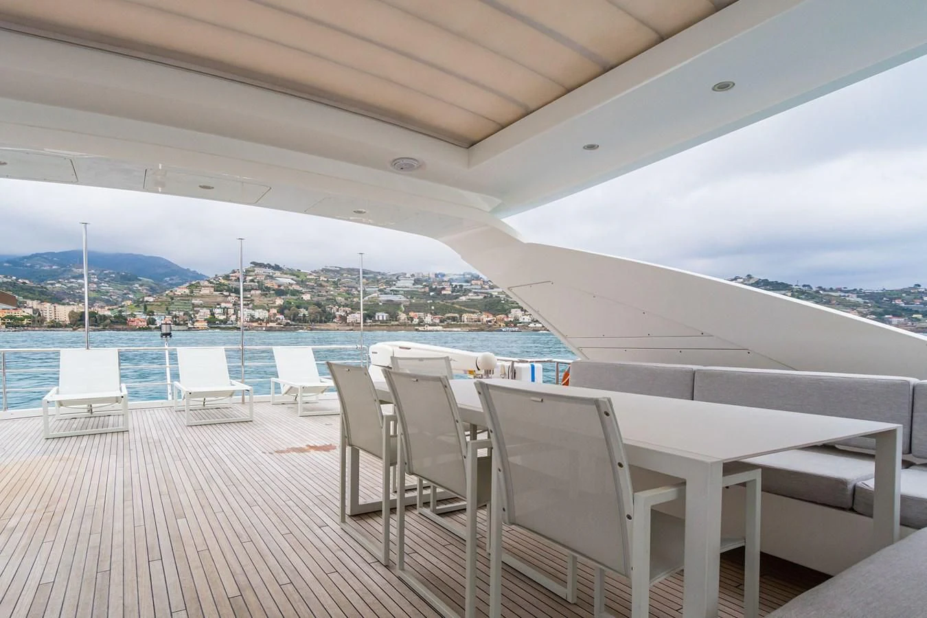 a deck with chairs and a view of a city aboard SOLSTICE Yacht for Sale