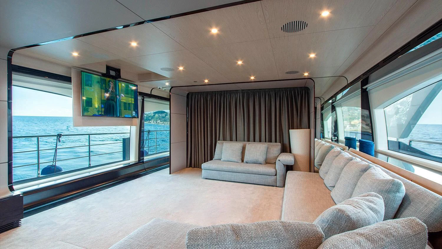 a living room with a large balcony aboard SOLSTICE Yacht for Sale