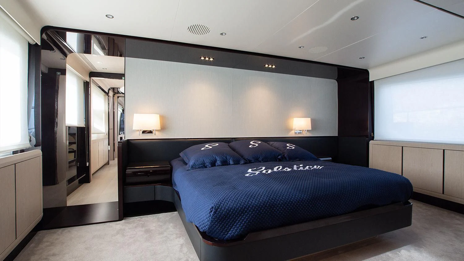 a bedroom with a bed and a desk aboard SOLSTICE Yacht for Sale