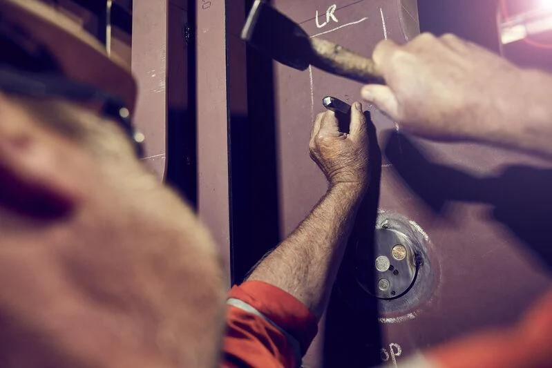 a man holding a black object aboard CINDERELLA NOEL IV Yacht for Sale