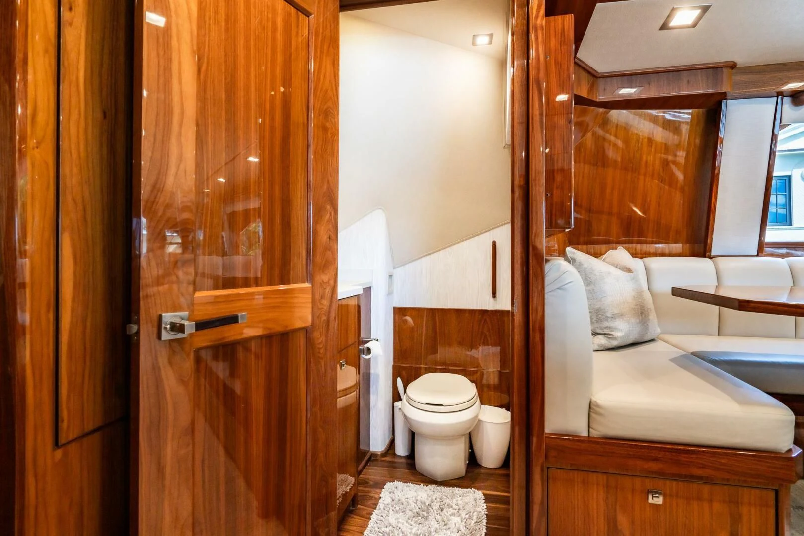 a bathroom with a wood door aboard FRIGATE Yacht for Sale