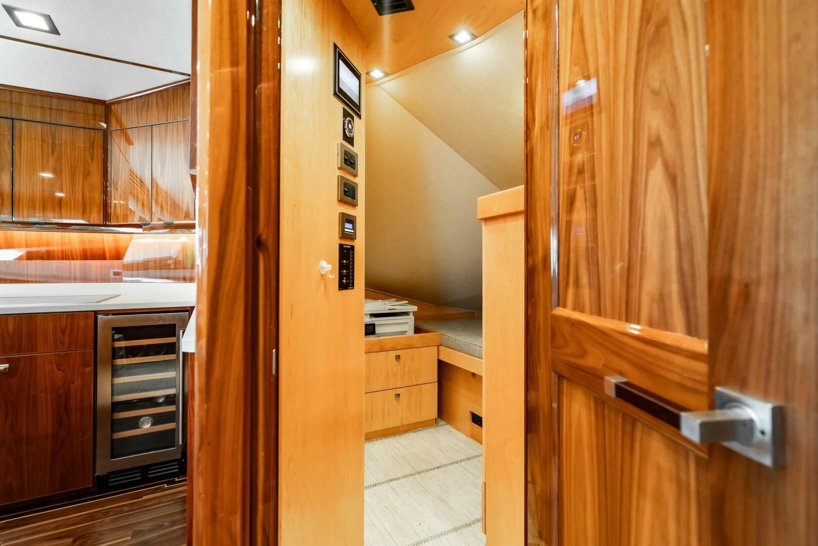 a kitchen with wooden cabinets aboard FRIGATE Yacht for Sale