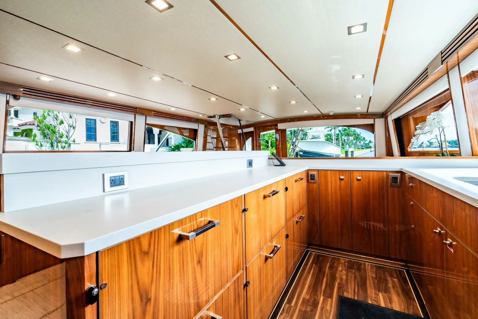 a kitchen with wooden cabinets aboard FRIGATE Yacht for Sale