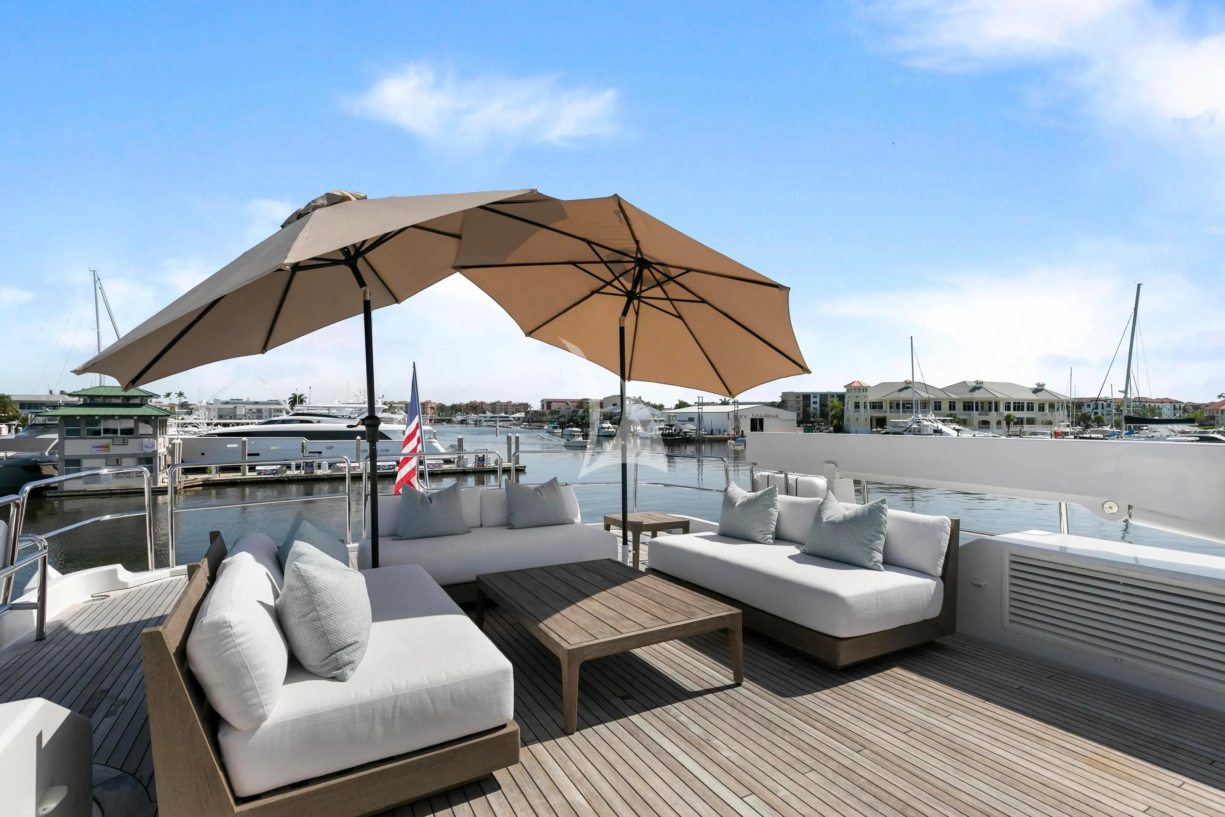 a deck with chairs and umbrellas aboard EDEN Yacht for Sale
