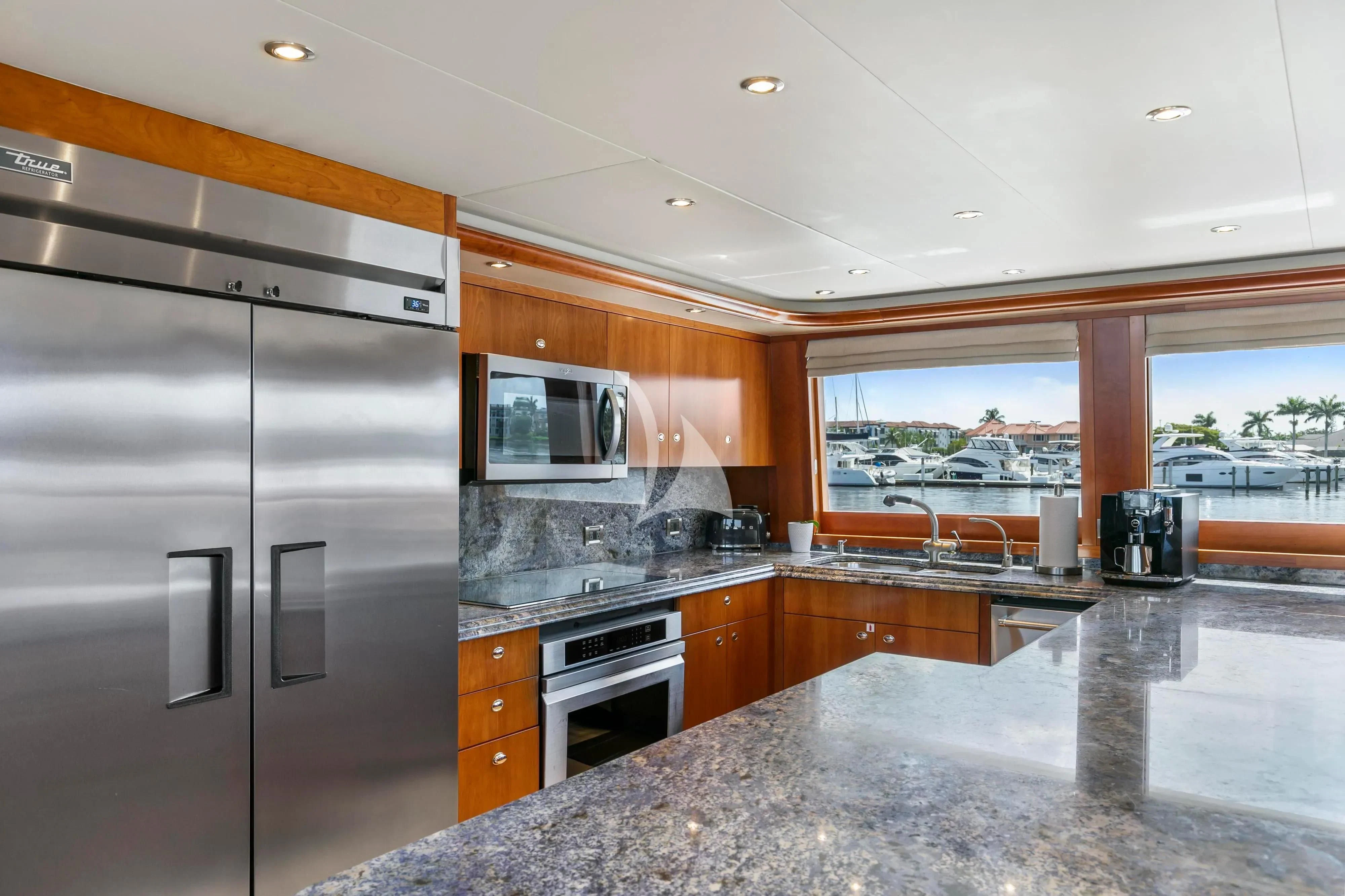 a kitchen with a stainless steel refrigerator aboard EDEN Yacht for Sale