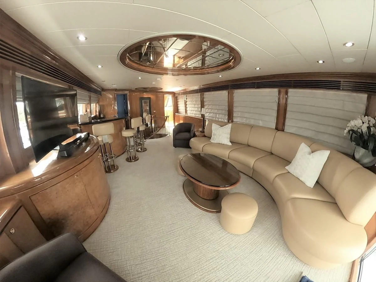 a large living room with a large chandelier aboard SEAS THE DAY Yacht for Sale