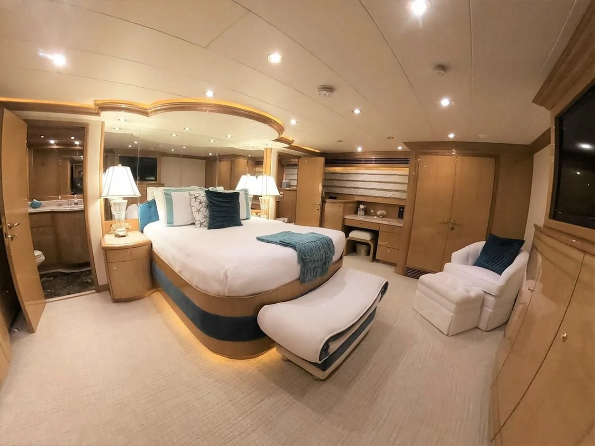 a large bedroom with a bed and a desk aboard SEAS THE DAY Yacht for Sale
