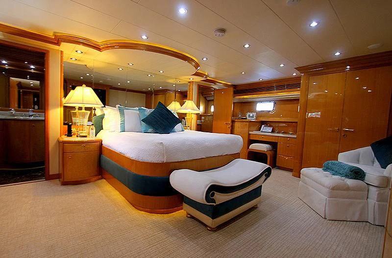 a bedroom with a bed and a chair aboard SEAS THE DAY Yacht for Sale