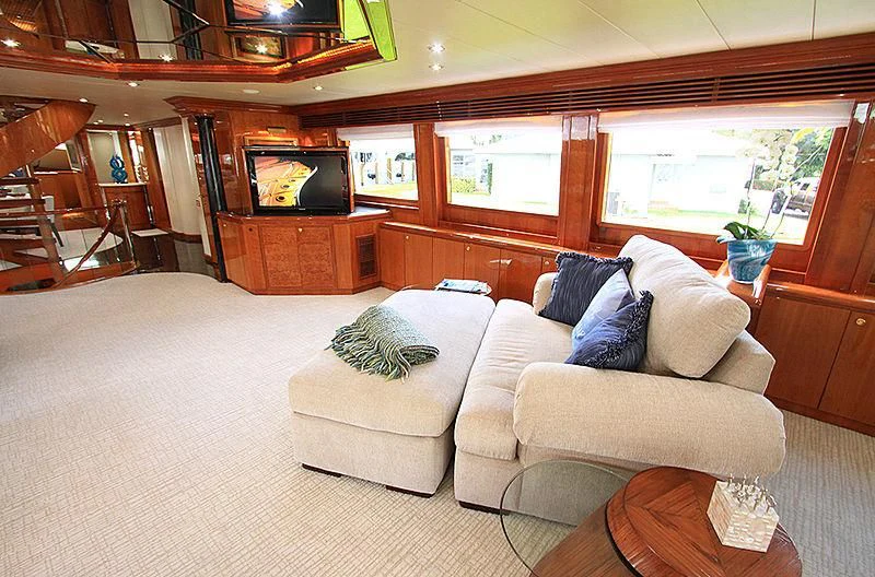a living room with a couch and a television aboard SEAS THE DAY Yacht for Sale