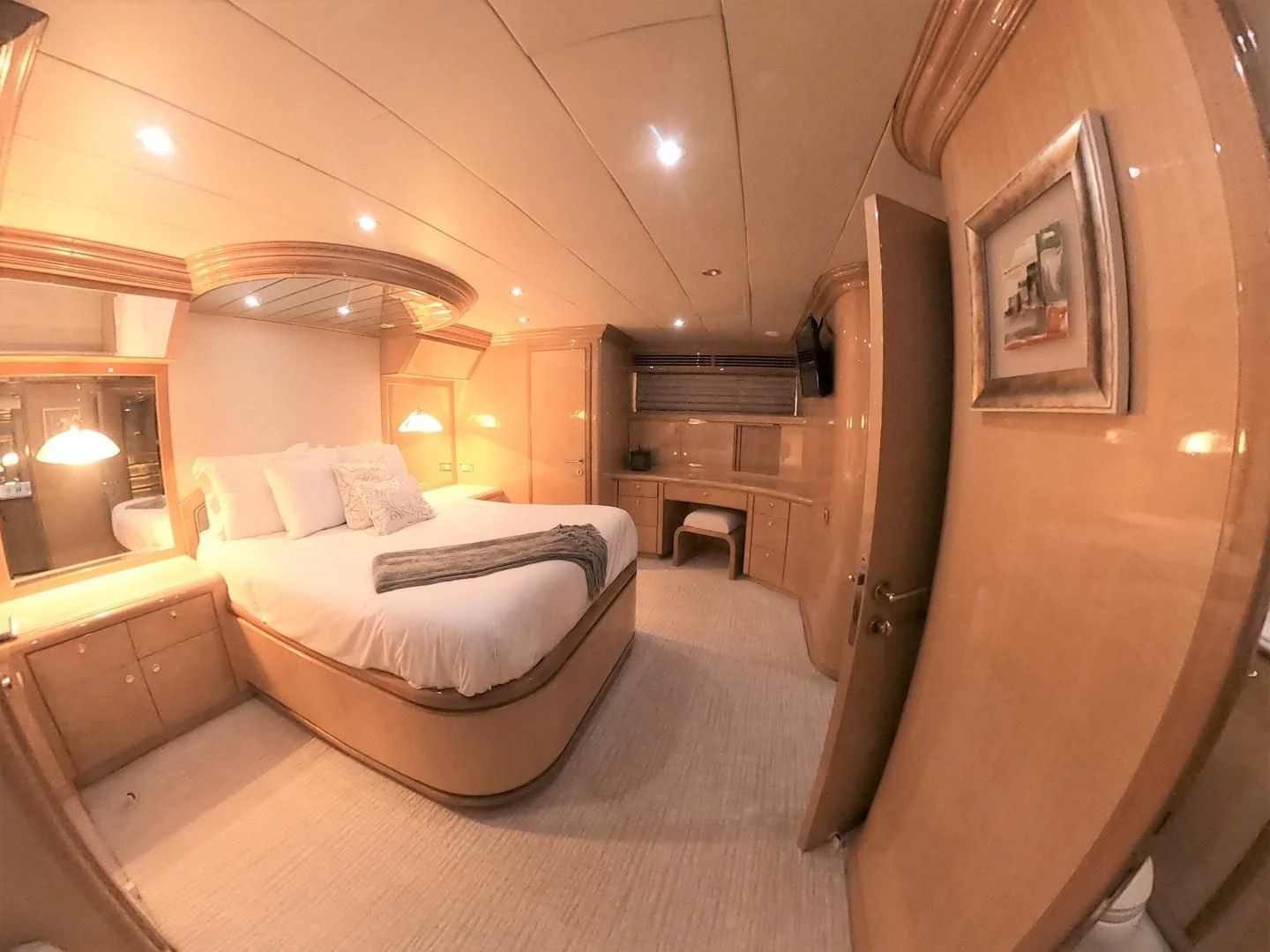 a bedroom with a bed and a mirror aboard SEAS THE DAY Yacht for Sale