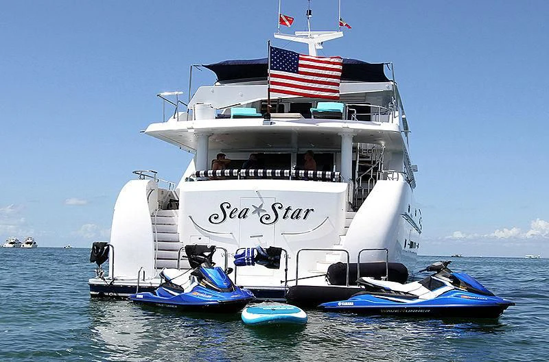 a boat with a flag on it aboard SEAS THE DAY Yacht for Sale