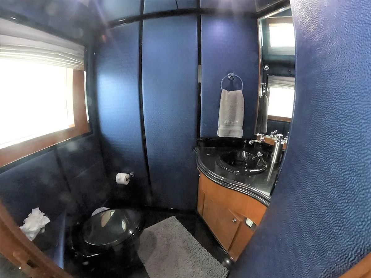 a bathroom with a sink and a window aboard SEAS THE DAY Yacht for Sale
