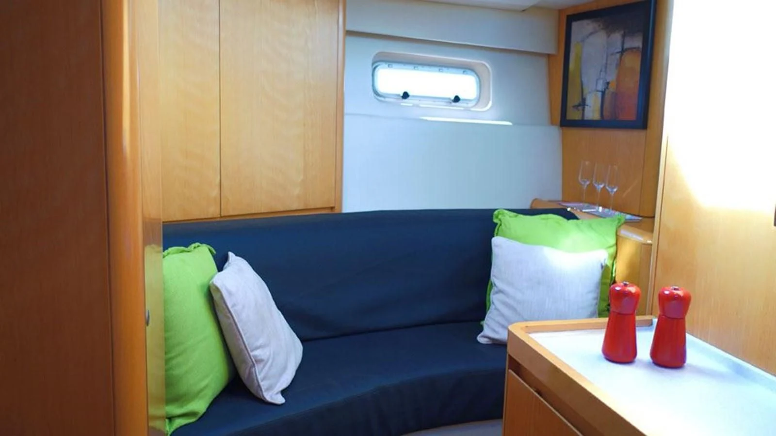 a room with a blue couch and pillows aboard LA LUNA Yacht for Sale