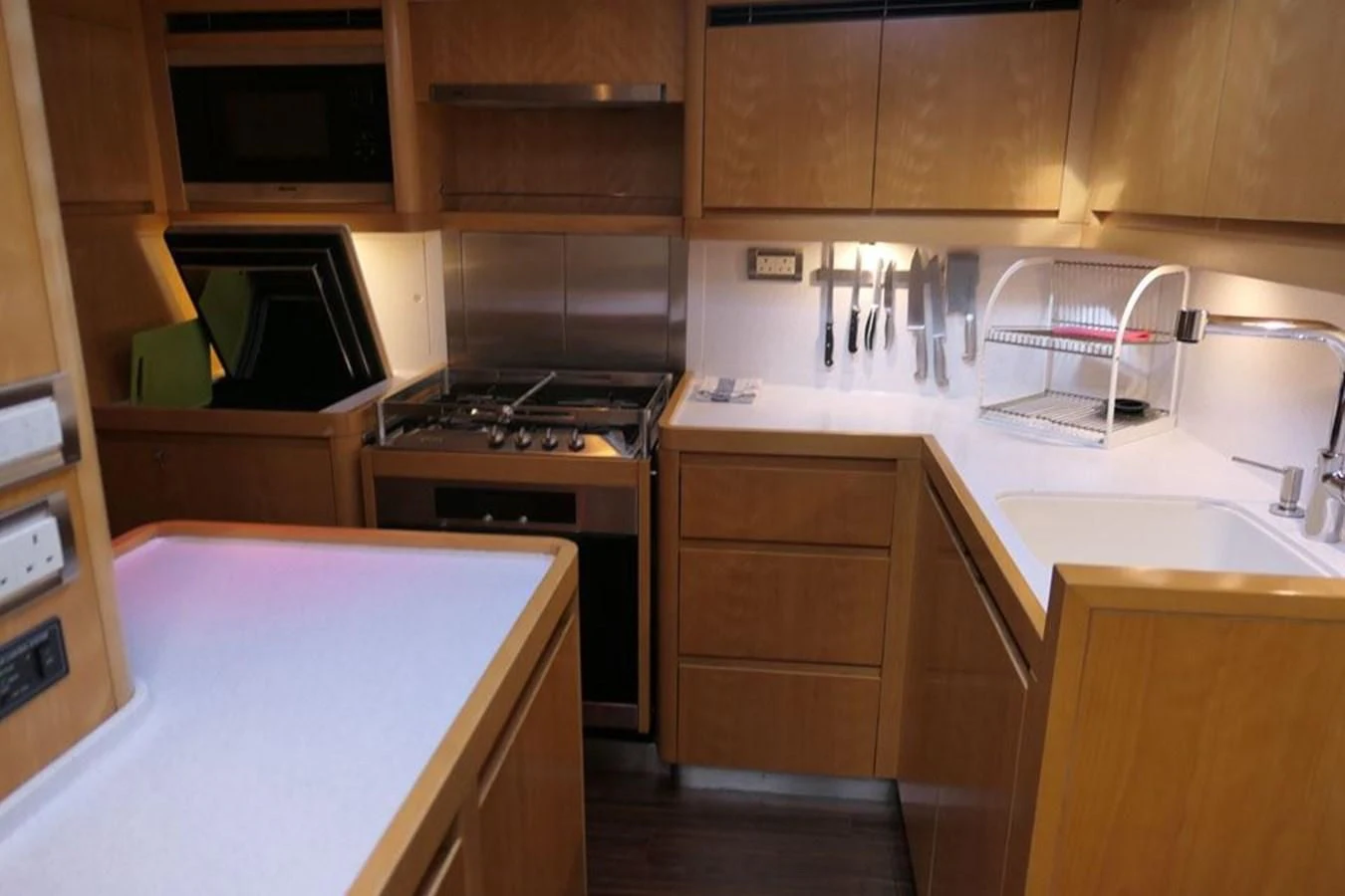 a kitchen with wooden cabinets aboard LA LUNA Yacht for Sale