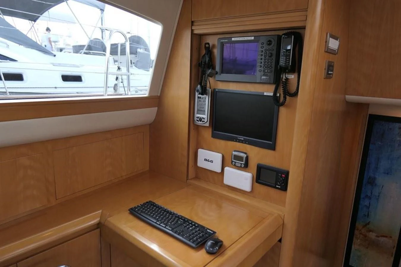 a desk with a computer and a television on it aboard LA LUNA Yacht for Sale