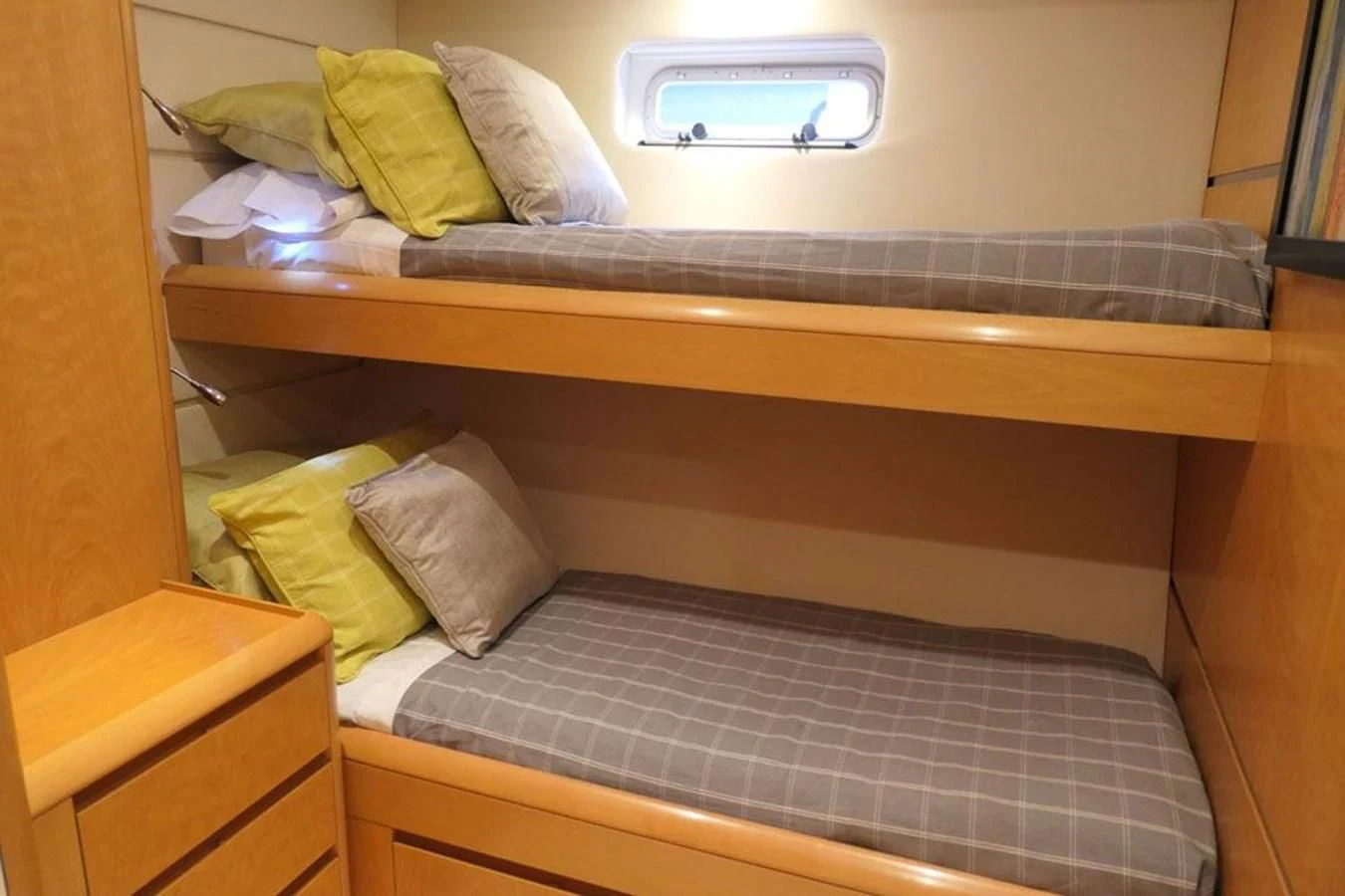 a bed with a striped comforter aboard LA LUNA Yacht for Sale