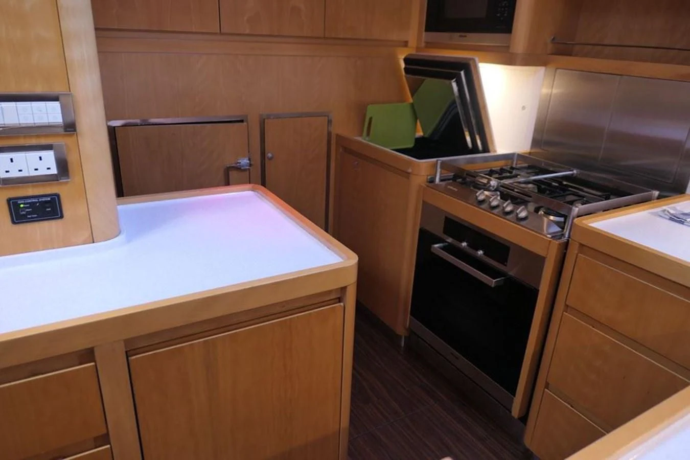a kitchen with wooden cabinets aboard LA LUNA Yacht for Sale