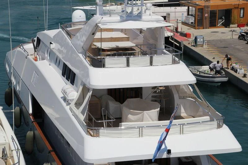 a boat with a deck and a deck with chairs on it aboard CAROLINE SEA II Yacht for Sale