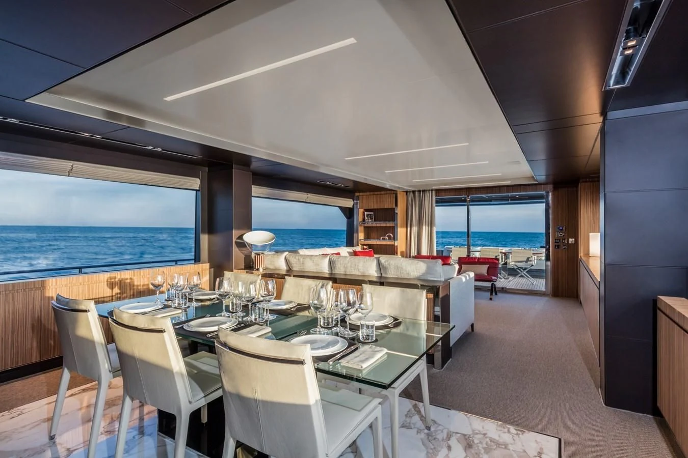 a room with tables and chairs aboard IRON GRYPHON Yacht for Sale