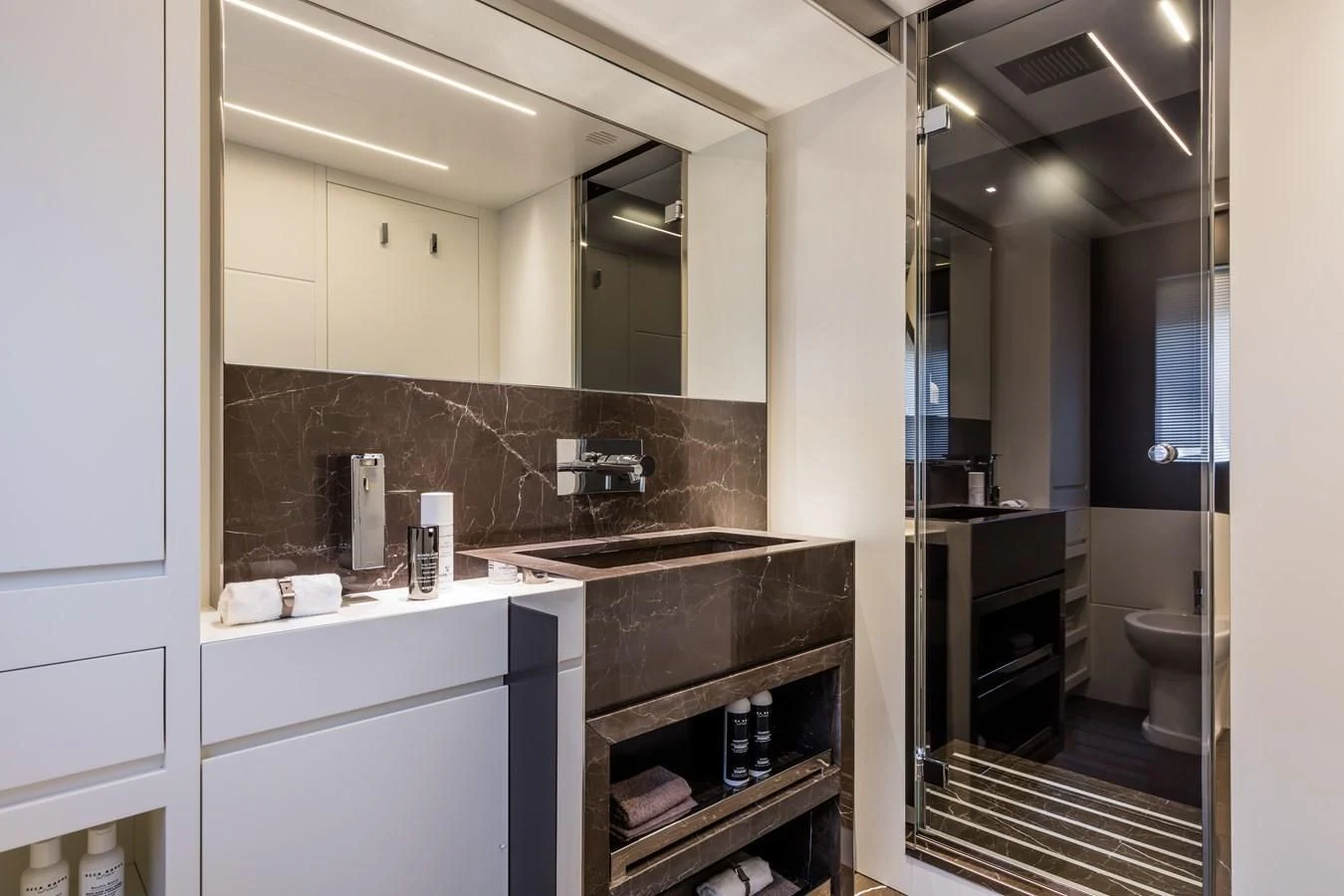 a bathroom with a large mirror aboard IRON GRYPHON Yacht for Sale