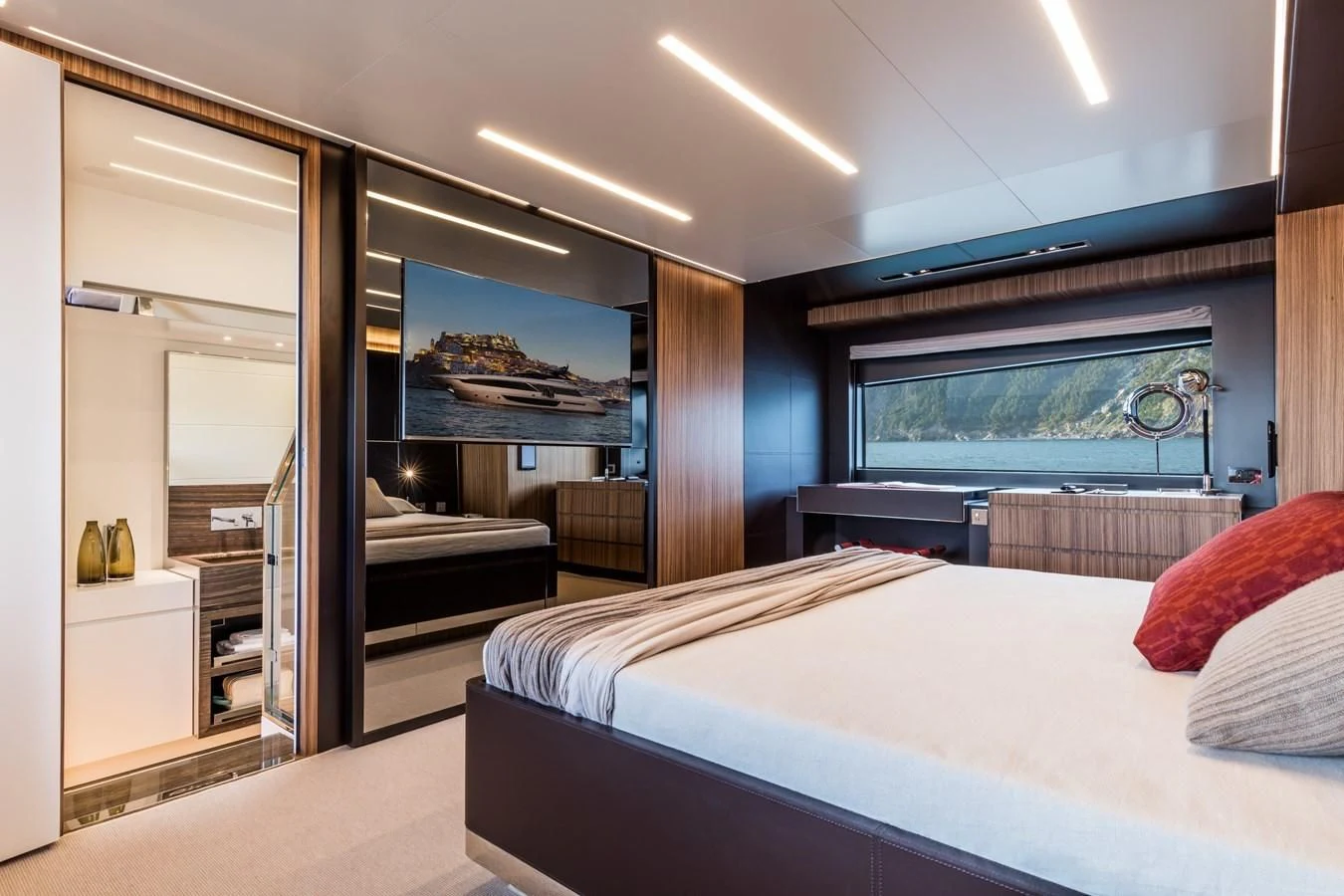 a room with a bed and a television aboard IRON GRYPHON Yacht for Sale