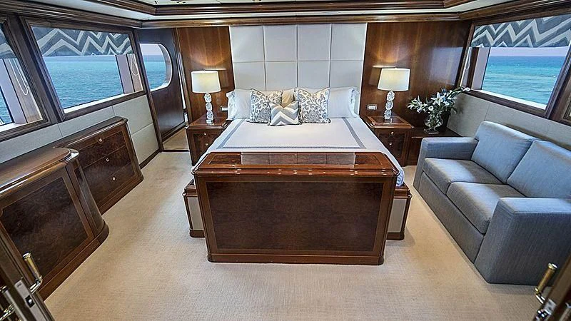 a large bedroom with a bed and a couch aboard CAMILLE Yacht for Sale