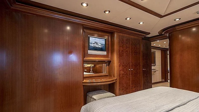 a room with a bed and a television aboard CAMILLE Yacht for Sale