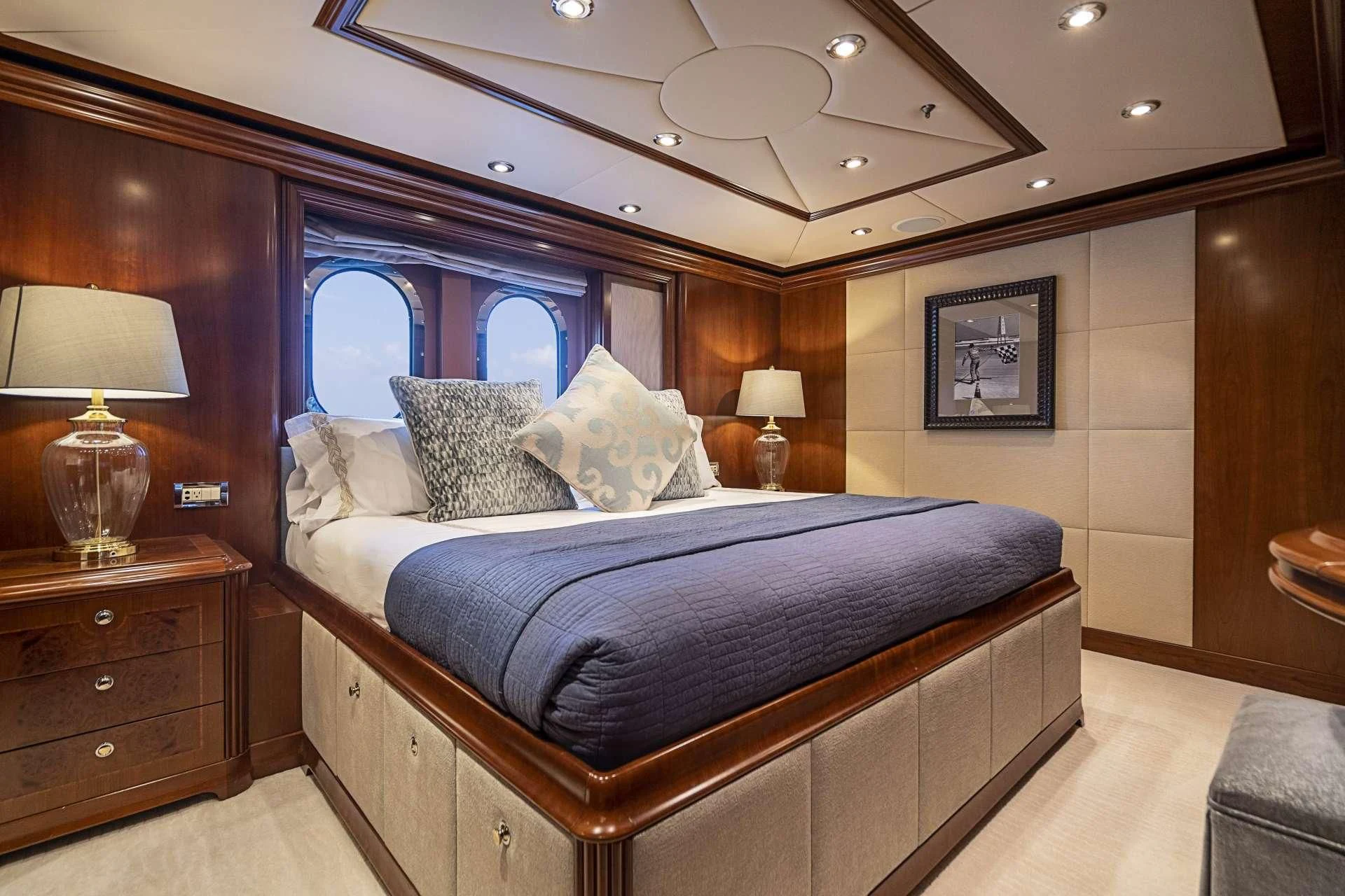 a bed with a blue comforter aboard CAMILLE Yacht for Sale