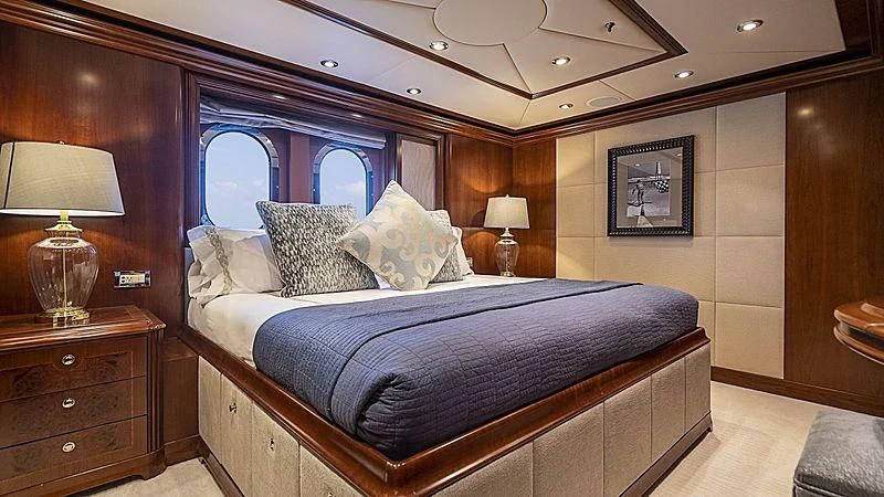 a bed with a blue comforter aboard CAMILLE Yacht for Sale
