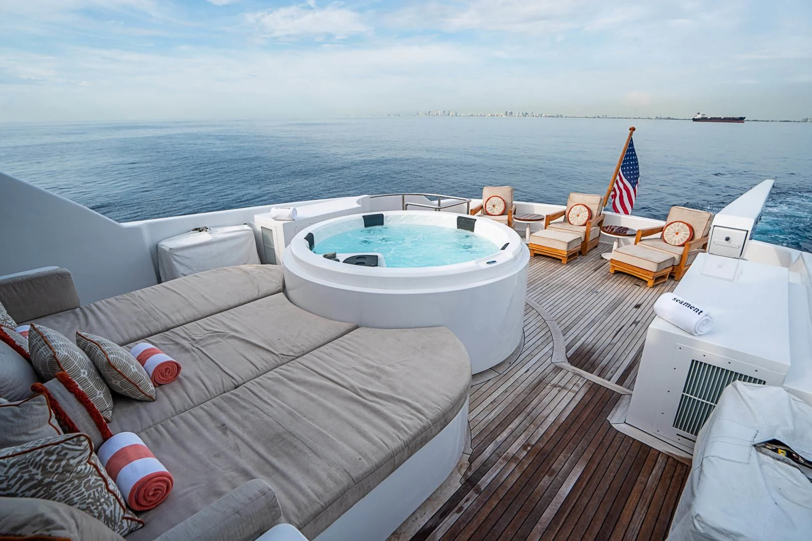 a large white tub on a deck overlooking a large body of water aboard CAMILLE Yacht for Sale