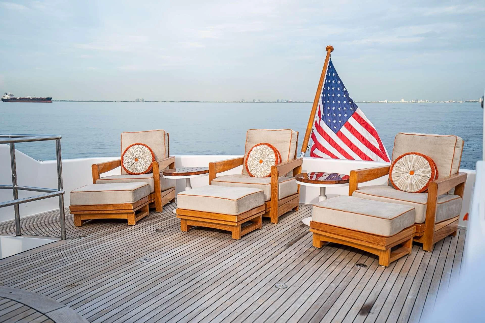 a deck with chairs and a flag aboard CAMILLE Yacht for Sale