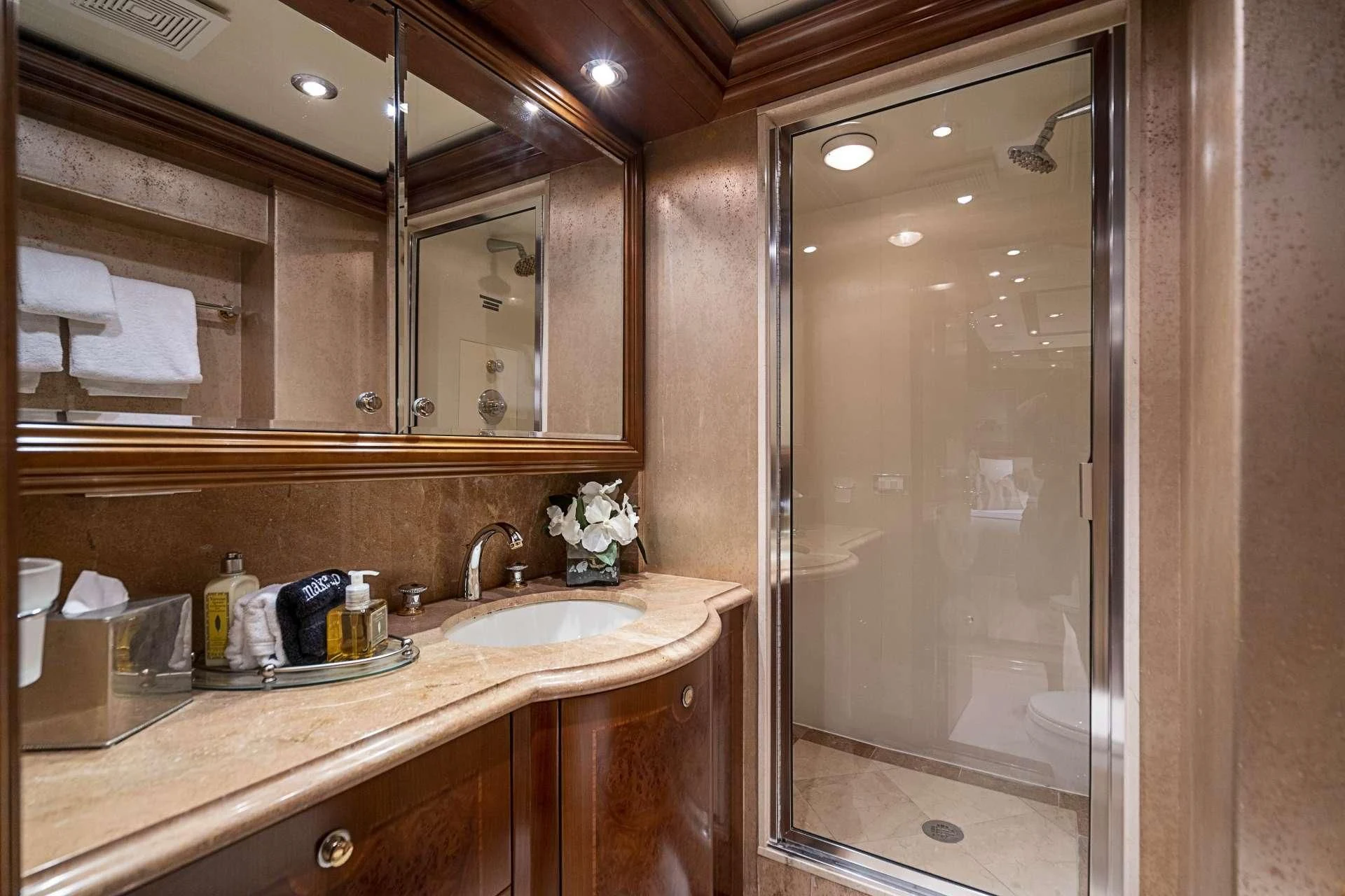 a bathroom with a glass shower door aboard CAMILLE Yacht for Sale