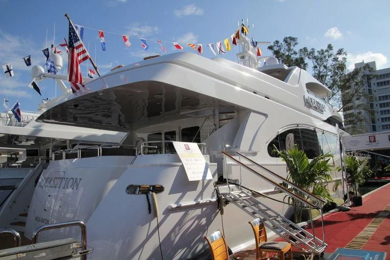 a large white boat with flags aboard CAMILLE Yacht for Sale